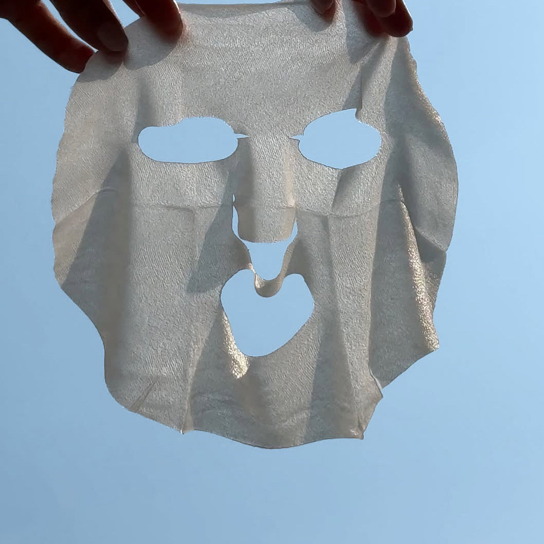 hands holding moodmask on a bright blue background