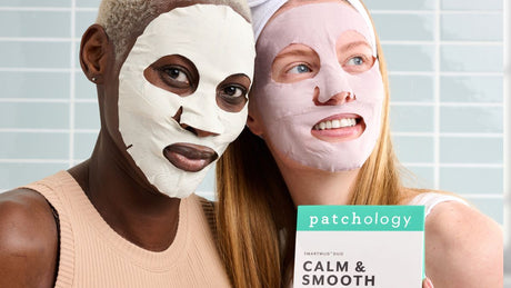 Two women wearing sheet face masks holding Patchology Calm & Smooth set for soothing skincare routine