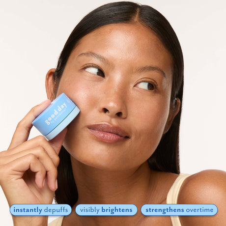 Woman holding Eye Pillow 360° Brightening Eye Cream, highlighting instant depuffing, visible brightening, and stronger-looking under-eye skin.