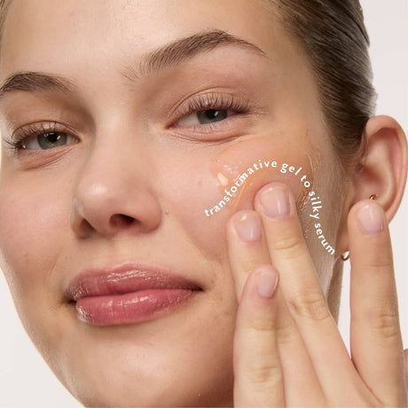 Woman applying Glow Potion Illuminating Superfood Serum as it transforms from gel to a silky serum.