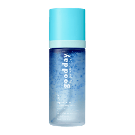 A bottle of Good Day Crystal Clear Refreshing Mineral Micro Facial Mist, featuring a light blue cap and a blue-to-clear gradient bottle, centered on a solid green background.