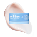 Blue jar of Eye Pillow 360° Brightening Eye Cream displayed over a pale peach cream swatch.