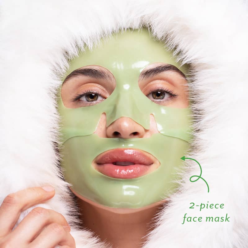 A woman wearing a green cool crush hydrogel face mask with a white hood on a light background