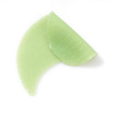 Green hydrogel under-eye patches with glossy gel texture for depuffing and soothing skincare treatment
