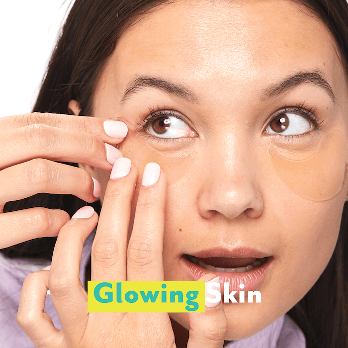 glowing skin. a woman applying eye gels