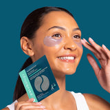 Woman applying eye patches with a Patchology product in a dark blue background